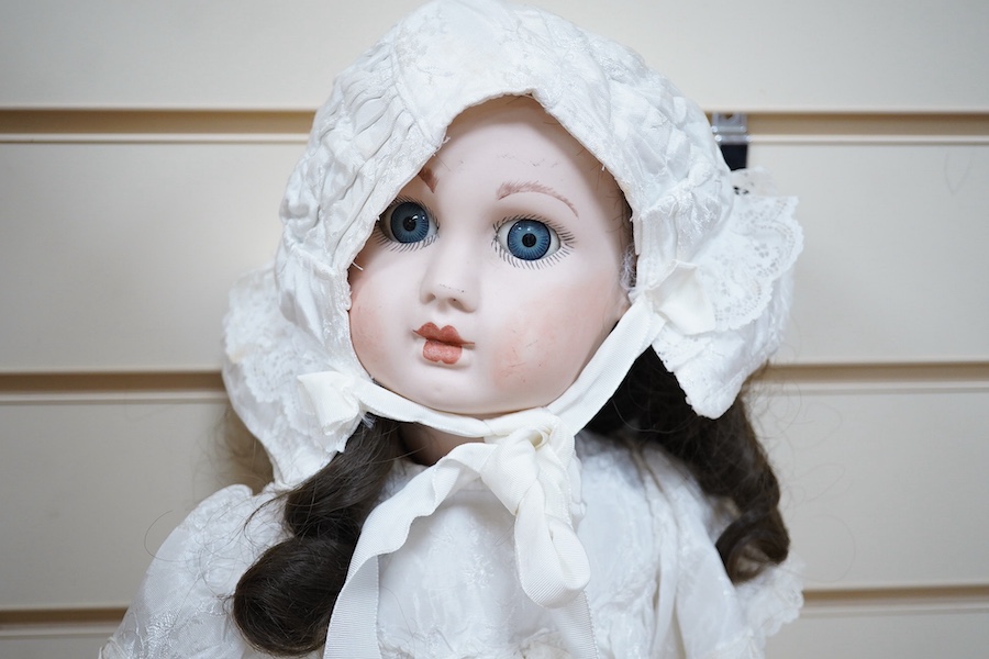 A. Jules Steiner bisque doll, closed mouth and fixed glass eyes, cloth body with jointed bisque lower-limbs, 62cm. Condition: head good.